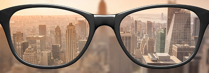 Glasses Showing a City Skyline In Focus Vs Without Glasses